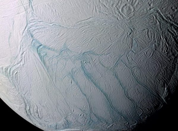 A view of Enceladus’ southern hemisphere in enhanced color (IR-green-UV). The “tiger stripe” fractures, the source of plumes venting gas and dust into space, are prominently visible in the center. {NASA/JPL-Caltech/SSI/Lunar and Planetary Institute, Paul Schenk (LPI, Houston)