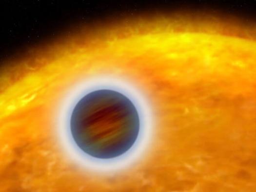 An artist rendering of a "hot Jupiter" extrasolar planet orbiting very close to its host star. The planet designated HD 209458b, is about the size of Jupiter. Unlike Jupiter, the planet is so hot that its atmosphere is "puffed up." Starlight is heating the planet's atmosphere, causing hot gas to escape into space, like steam rising from a boiler. (NASA, ESA, and G. Bacon (STScI).
